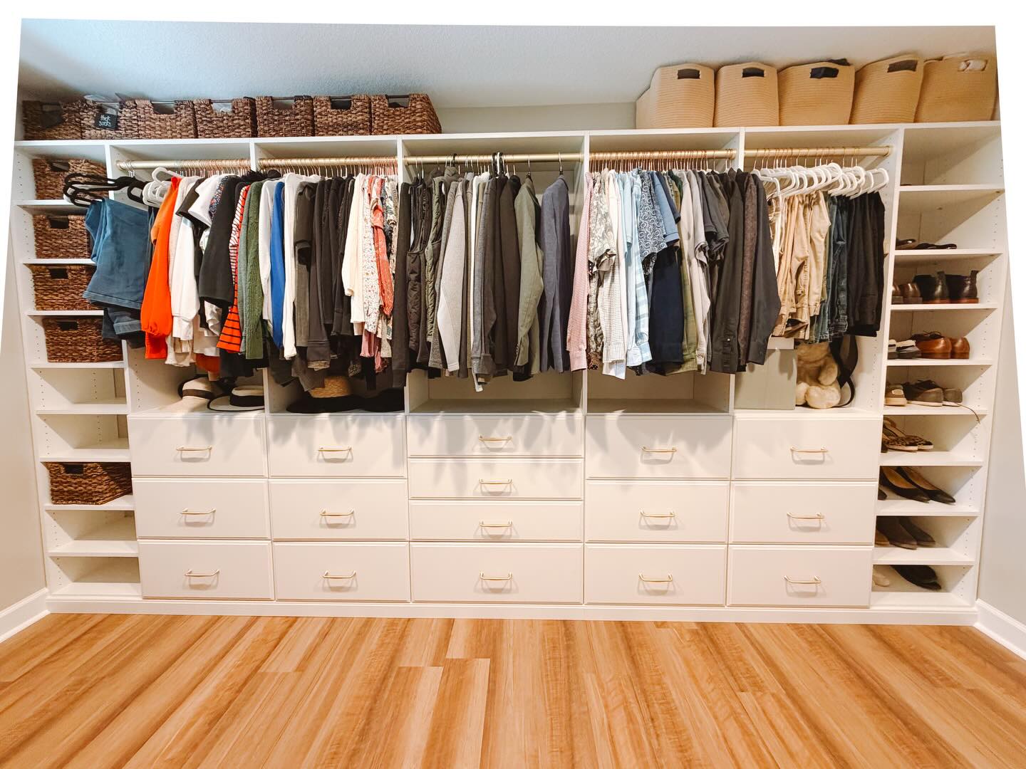 Full wall walk-in closet with drawers and hanging